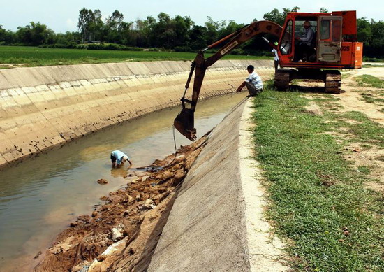 Công ty TNHH KTCTTL Bình Định khắc phục một điểm sạt lở kênh mương trên địa bàn xã Bình Thành (huyện Tây Sơn). Ảnh: N.HÂN